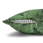 Green patterned pillow with a zipper on a white background