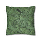 Green decorative pillow with leaf pattern on a white background