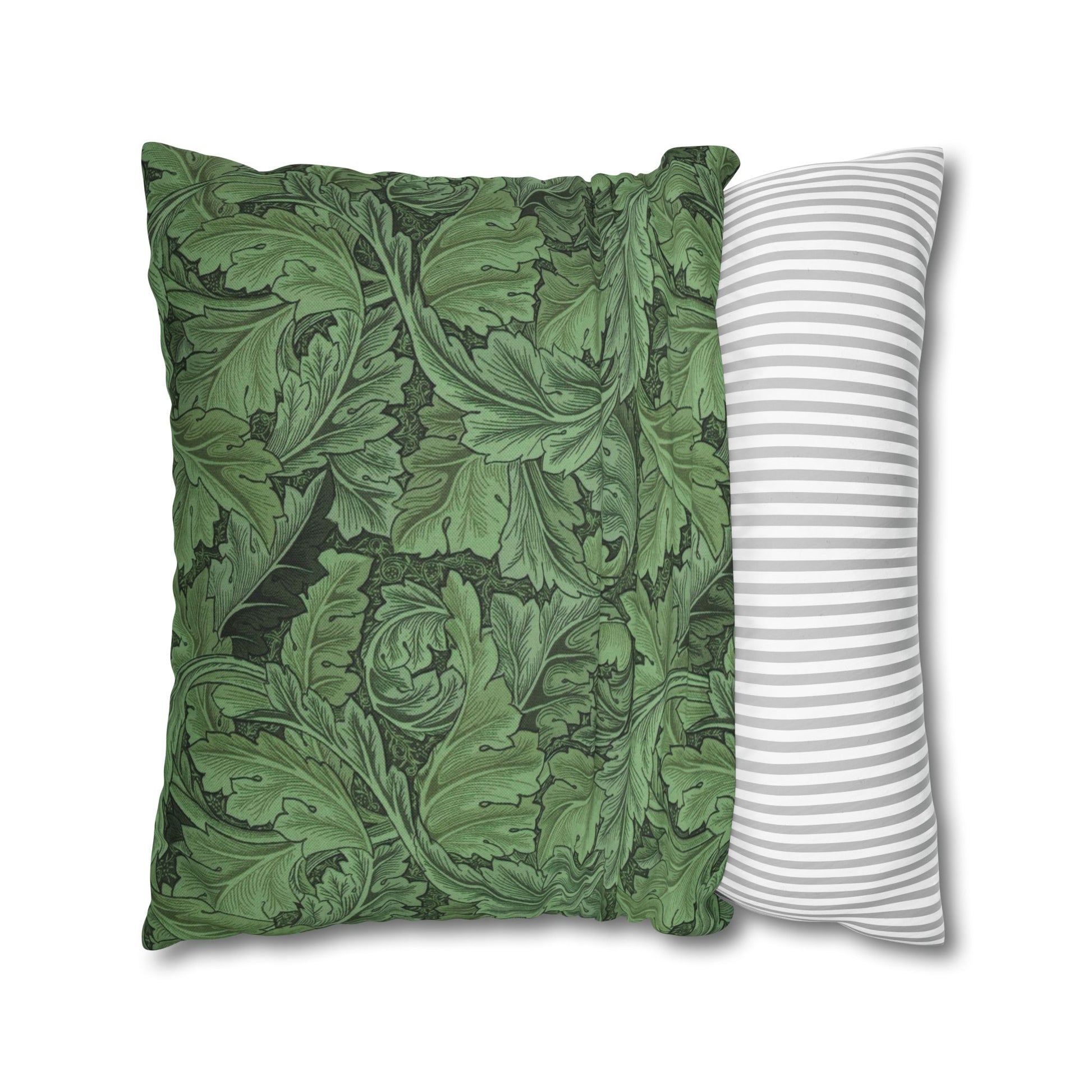 Two pillows, one with green leaf pattern and the other with white stripes, on a white background.