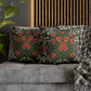 Decorative pillows with floral patterns on a gray sofa.