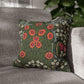 Floral patterned pillow on a gray sofa with a blurred background
