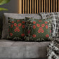 Decorative pillows with floral patterns on a gray sofa against a wooden panel wall.
