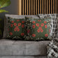 Decorative pillows with floral pattern on a gray sofa against a wooden headboard.