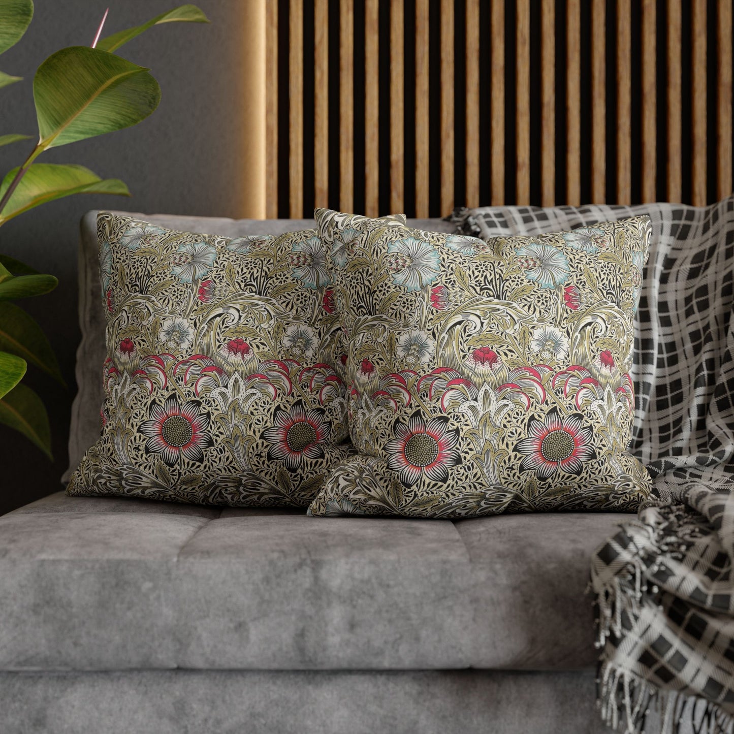 Decorative pillows with floral patterns on a gray sofa.