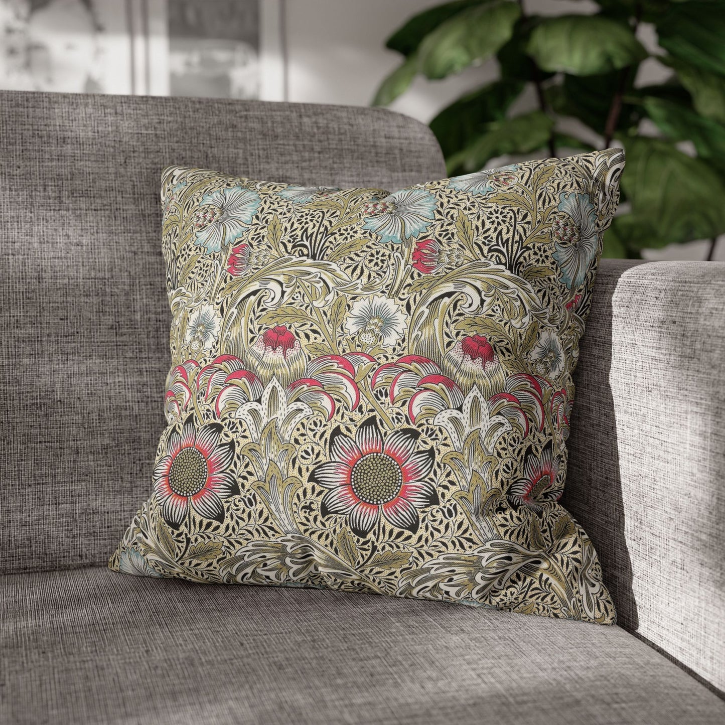 Decorative floral pillow on a gray sofa with a blurred indoor background