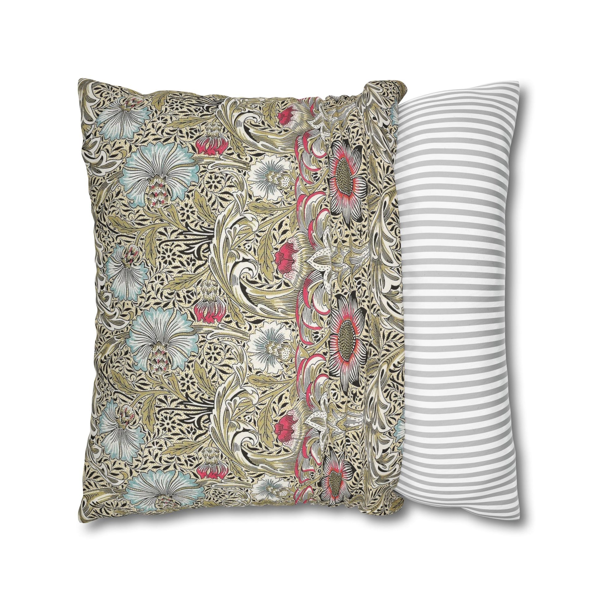 Decorative pillow with floral pattern next to a striped pillow on a white background