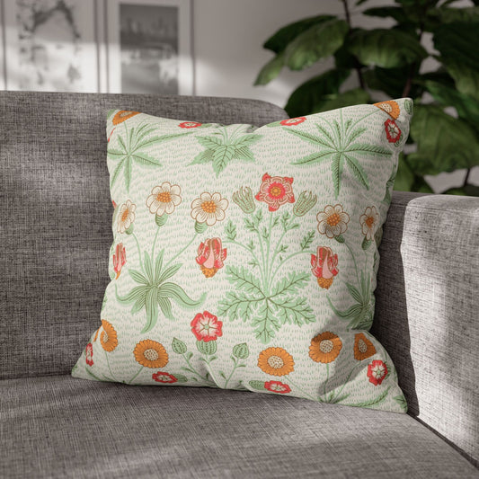Floral patterned pillow on a gray sofa with a blurred indoor background