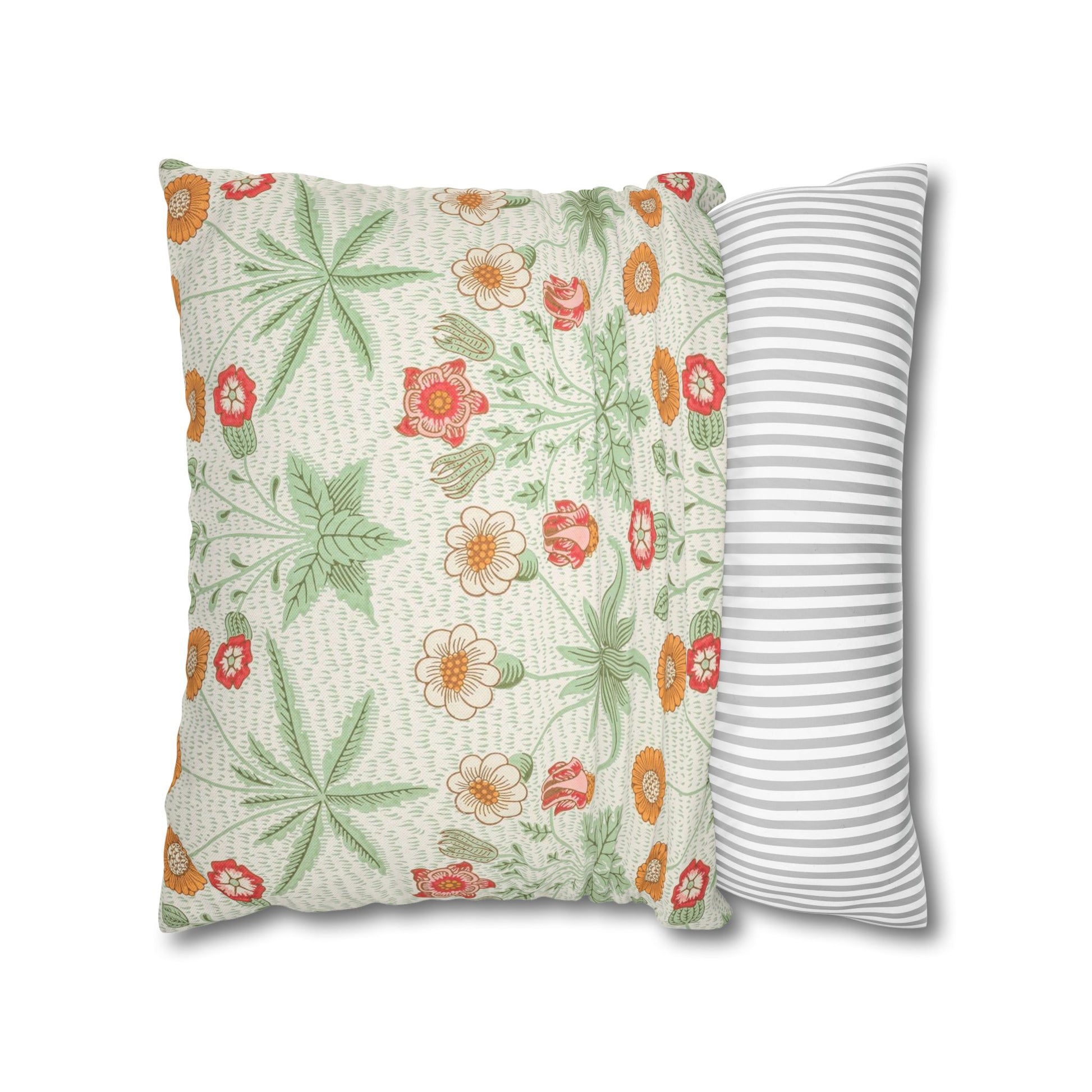 Two pillows, one with floral pattern and the other with stripes, on a white background.