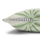 Green leaf-patterned pillow with a zipper on a white background