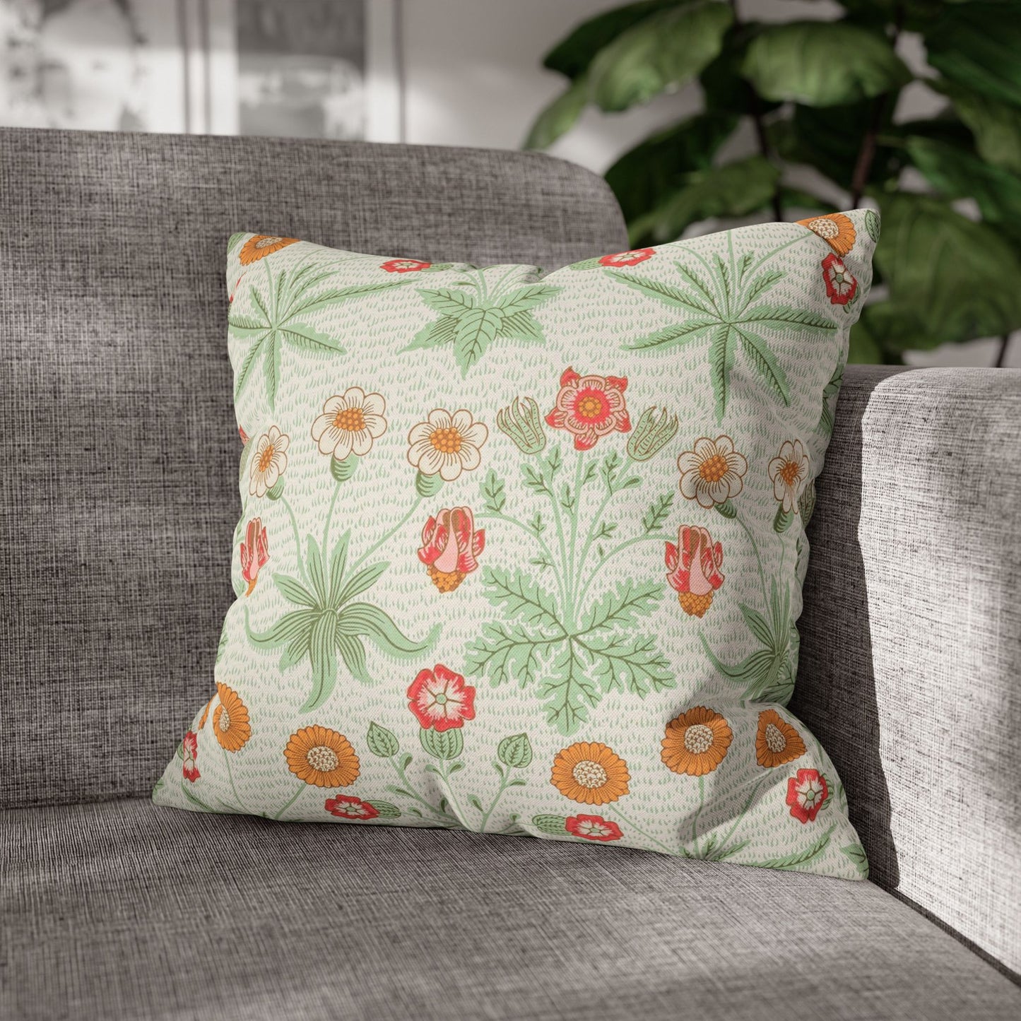 Decorative pillow with floral pattern on a gray sofa