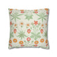 Floral patterned pillow with green leaves and red flowers on a white background