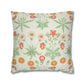 Floral patterned pillow with green leaves and colorful flowers on a white background