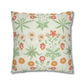 Floral patterned pillow with green leaves and colorful flowers on a white background