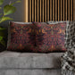 Decorative pillows with intricate patterns on a gray sofa.