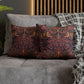 Decorative pillows with intricate patterns on a gray sofa.