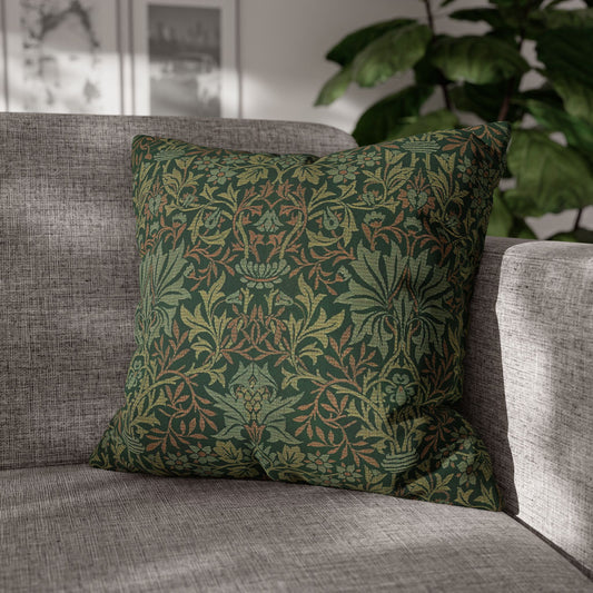 Green patterned pillow on a gray sofa with a blurred indoor background