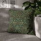 Green patterned pillow on a gray sofa with a blurred indoor background