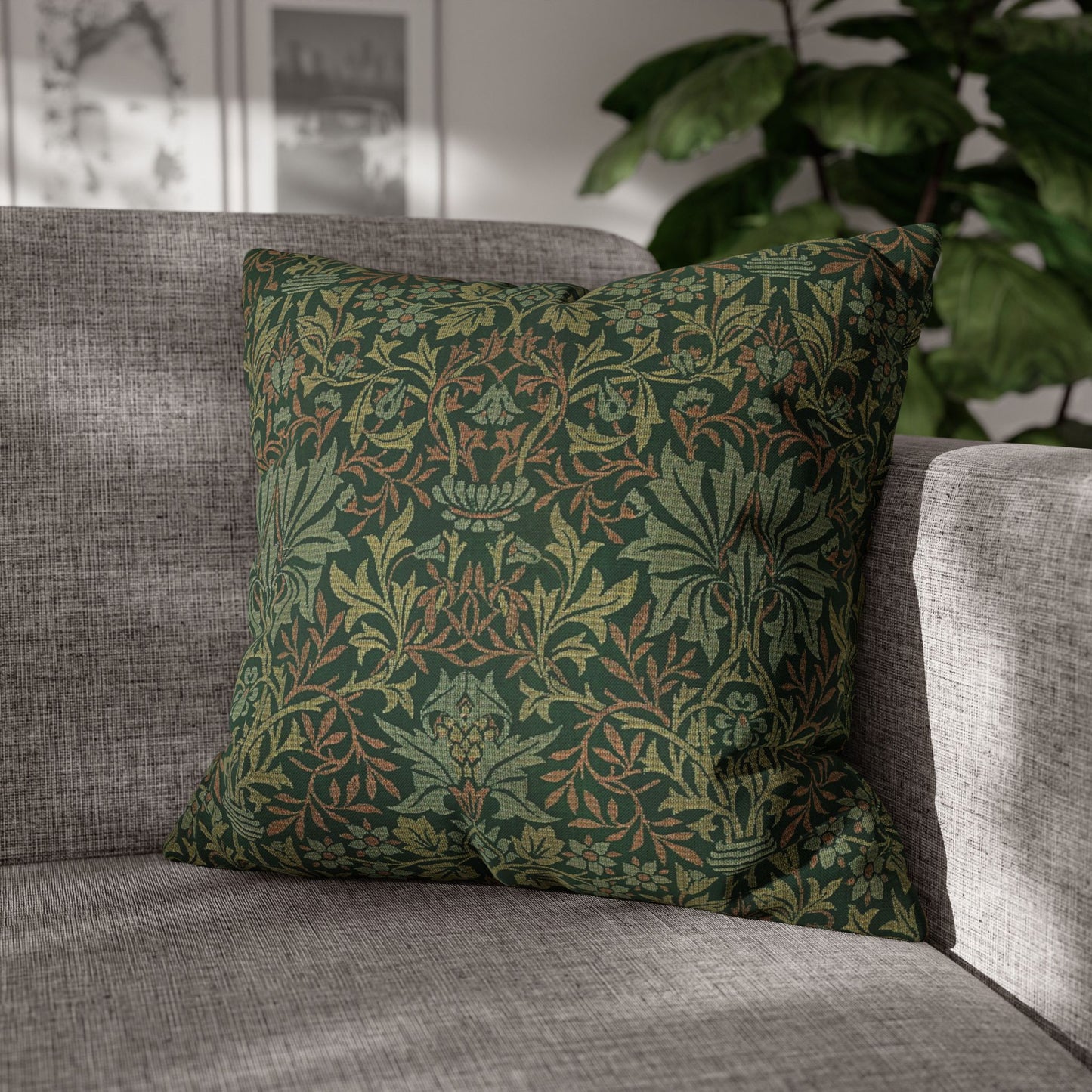 Green patterned pillow on a gray sofa with a blurred indoor background