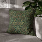 Green patterned pillow on a gray sofa with a blurred indoor background