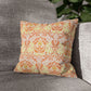Decorative pillow with orange and green pattern on a gray couch - William Morris Golden Bough