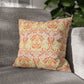 Decorative pillow with orange and green pattern on a gray sofa - William Morris Golden Bough