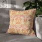 Decorative pillow with orange and green pattern on a gray sofa