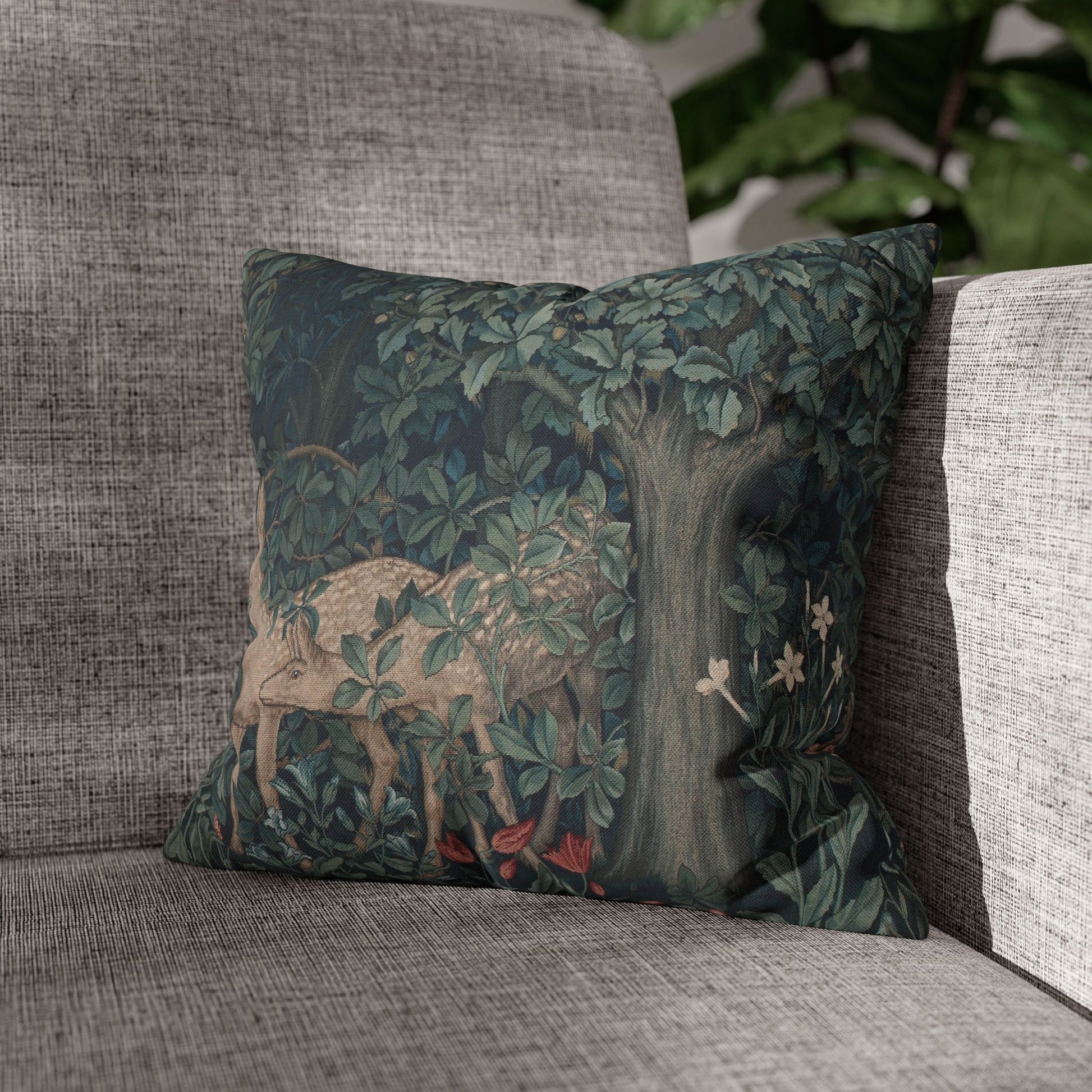 Decorative pillow with nature-themed design on a gray sofa