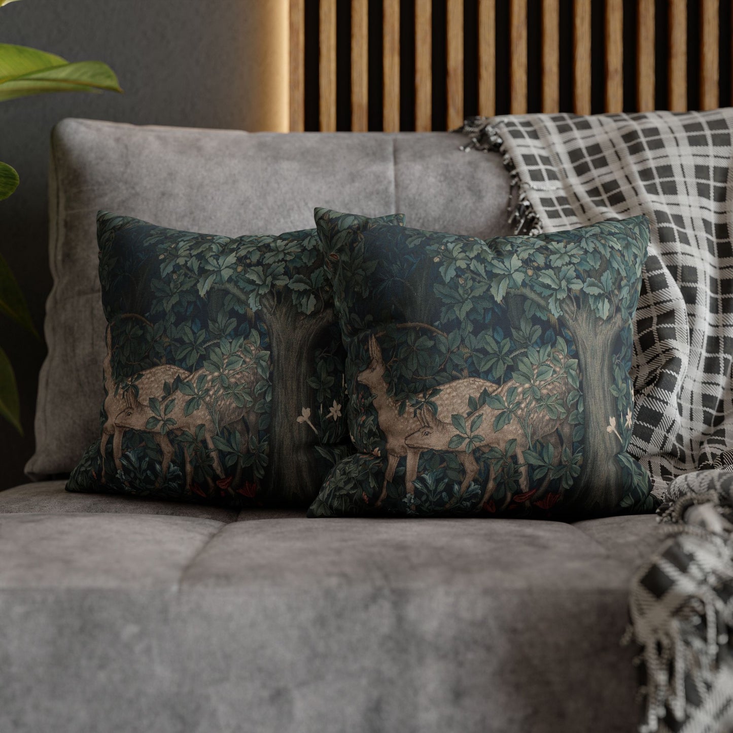 Decorative pillows with deer design on a gray sofa