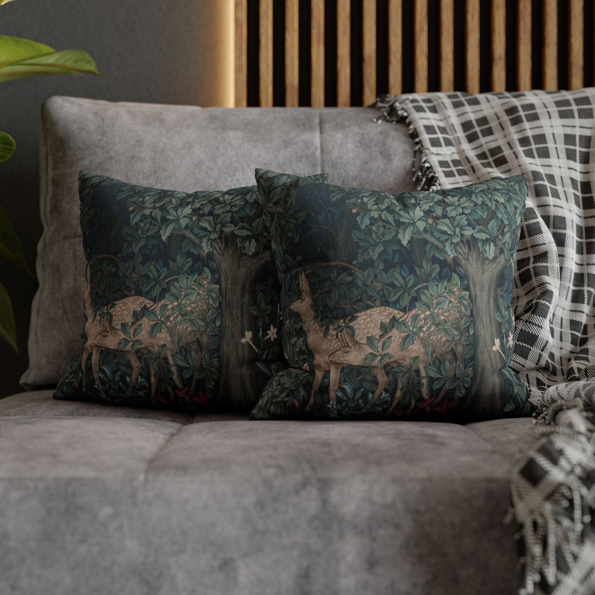 Decorative pillows with deer design on a gray sofa