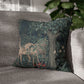 Decorative pillow with a nature-themed design featuring a deer and trees on a gray sofa.