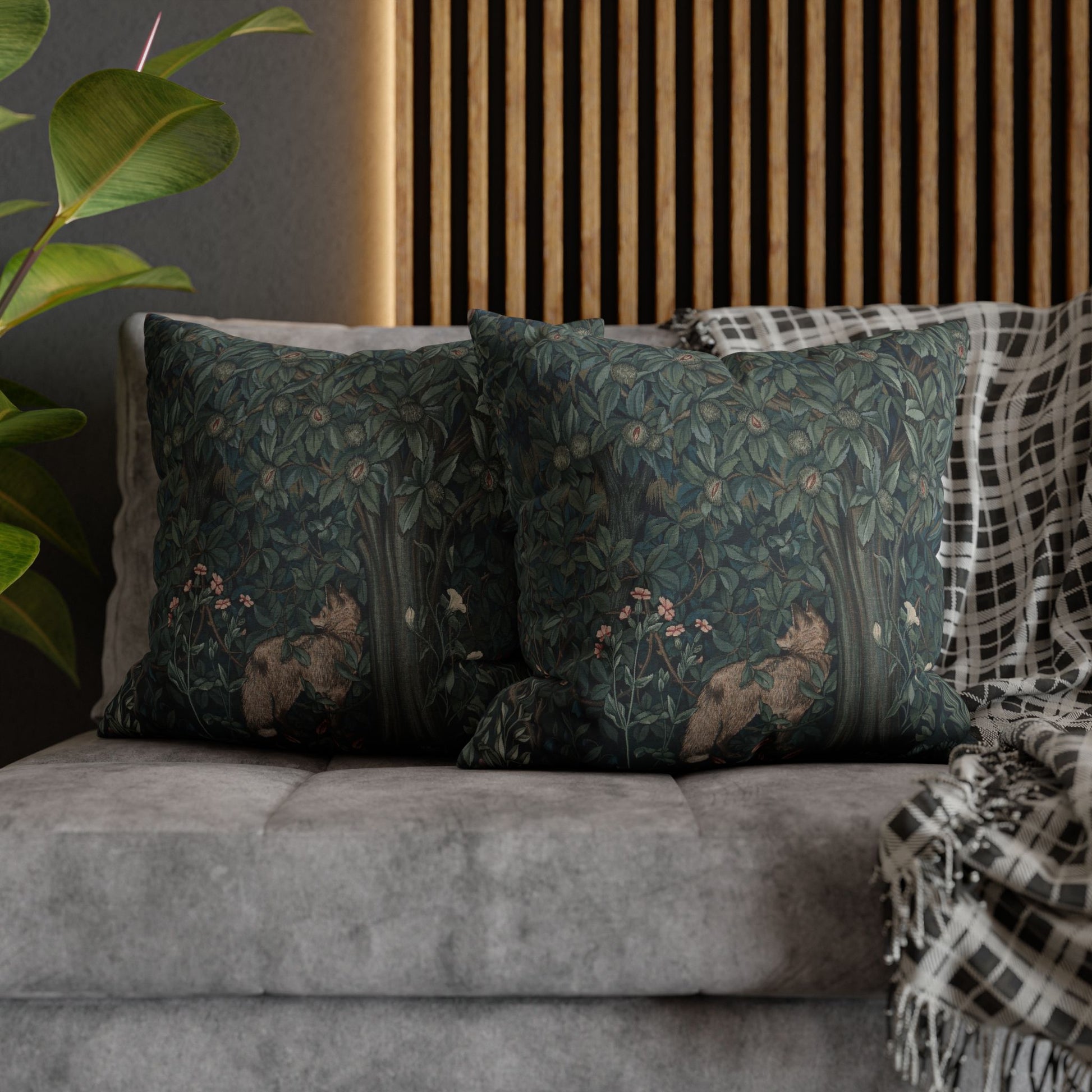Decorative pillows with nature-themed designs on a gray sofa against a wooden panel wall - William Morris Greenery