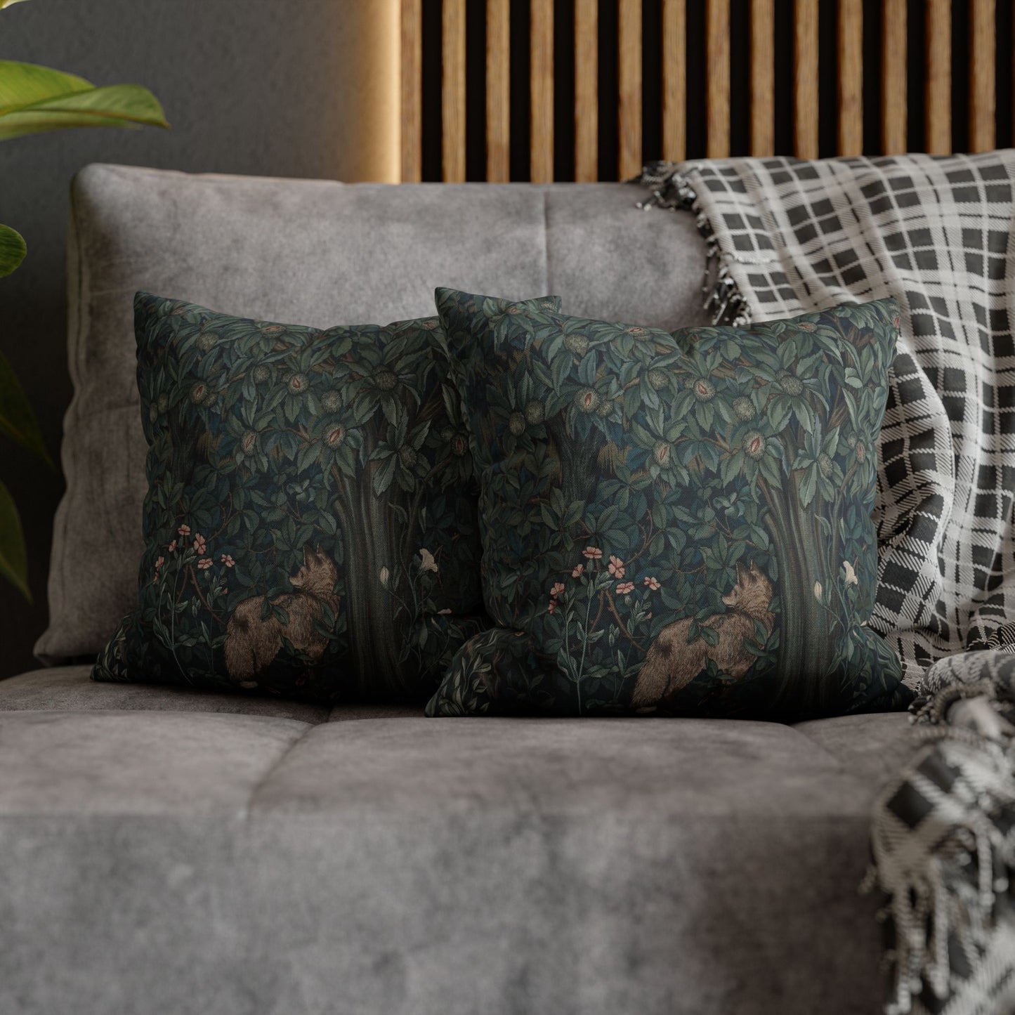 Gray sofa with decorative pillows and a plaid blanket against a wooden headboard - William Morris Greenery