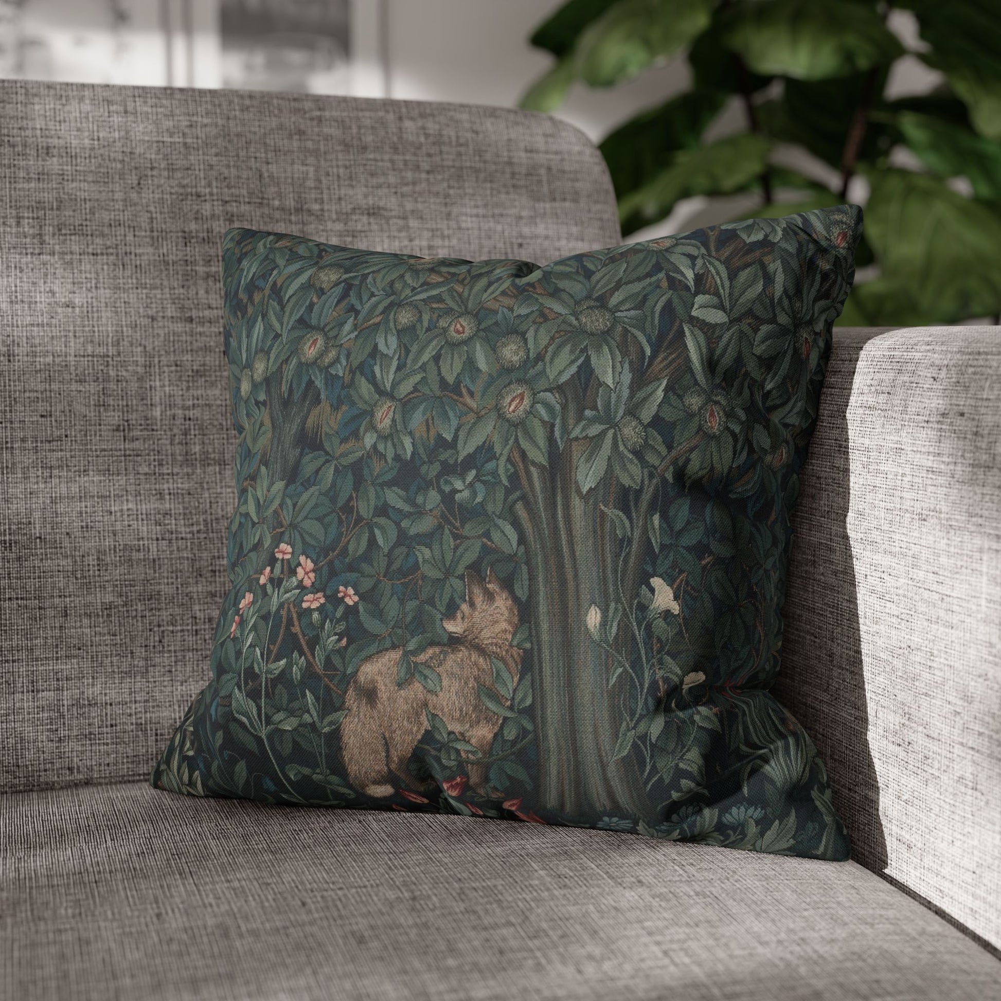 Decorative pillow with nature-themed design on a gray sofa - William Morris Greenery