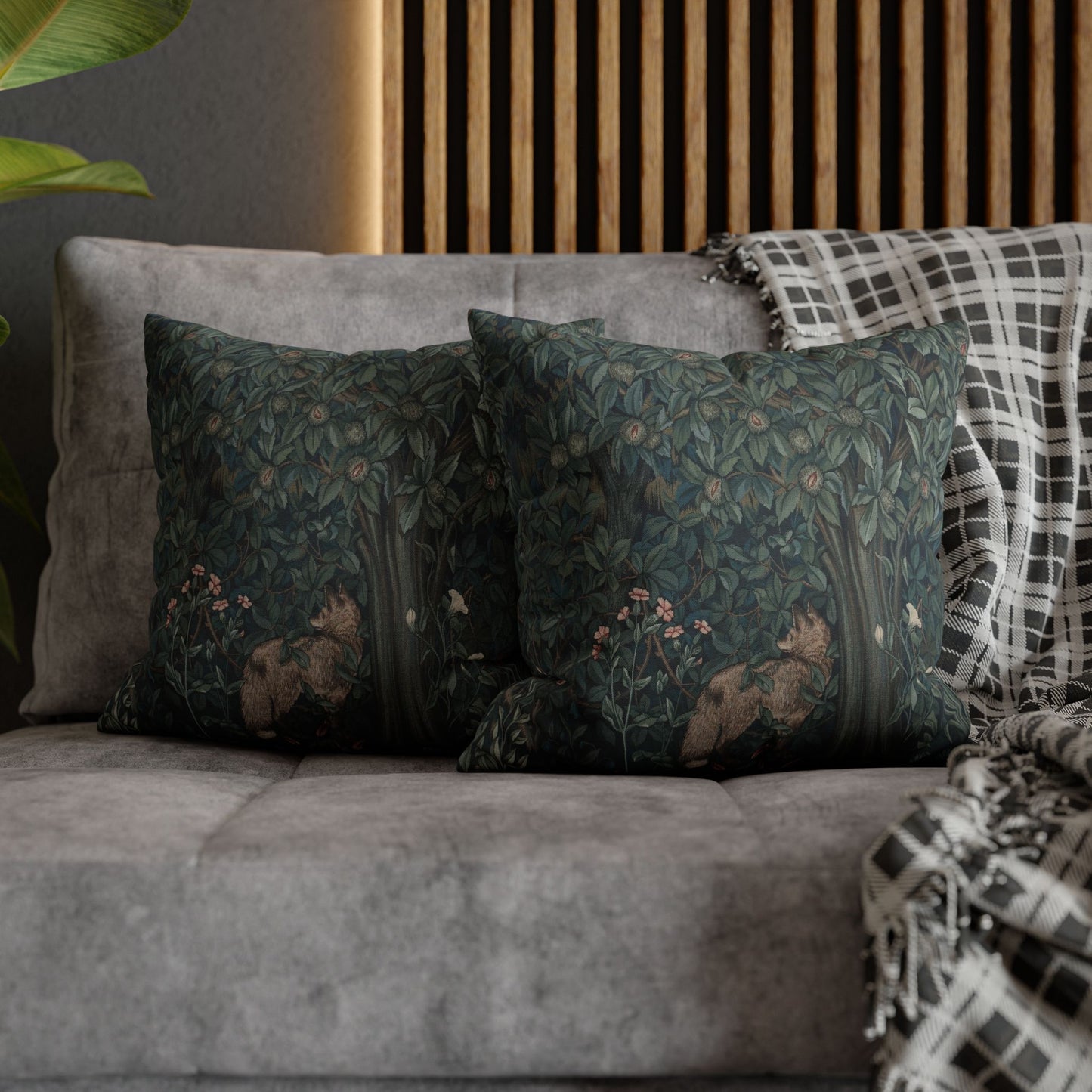 Decorative pillows with floral patterns on a gray sofa against a wooden headboard - William Morris Greenery