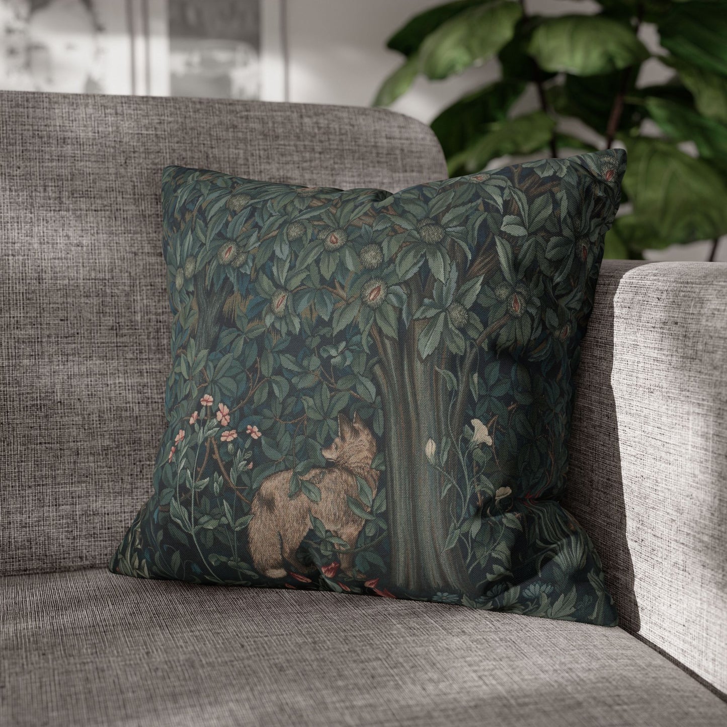 Decorative pillow with nature-themed design on a gray sofa - William Morris Greenery