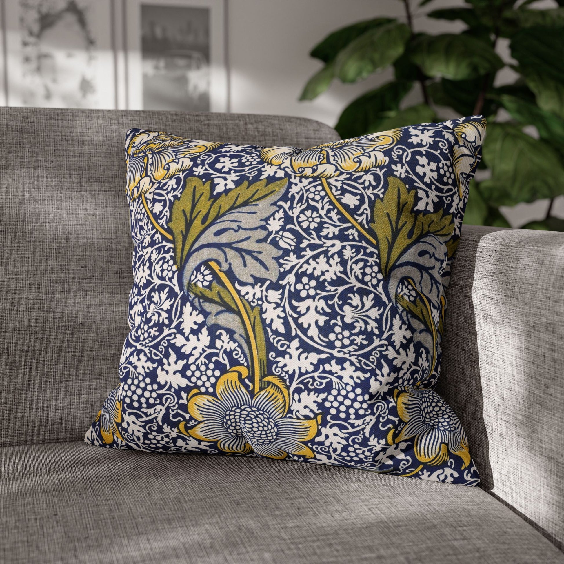 Decorative pillow with floral pattern on a gray sofa