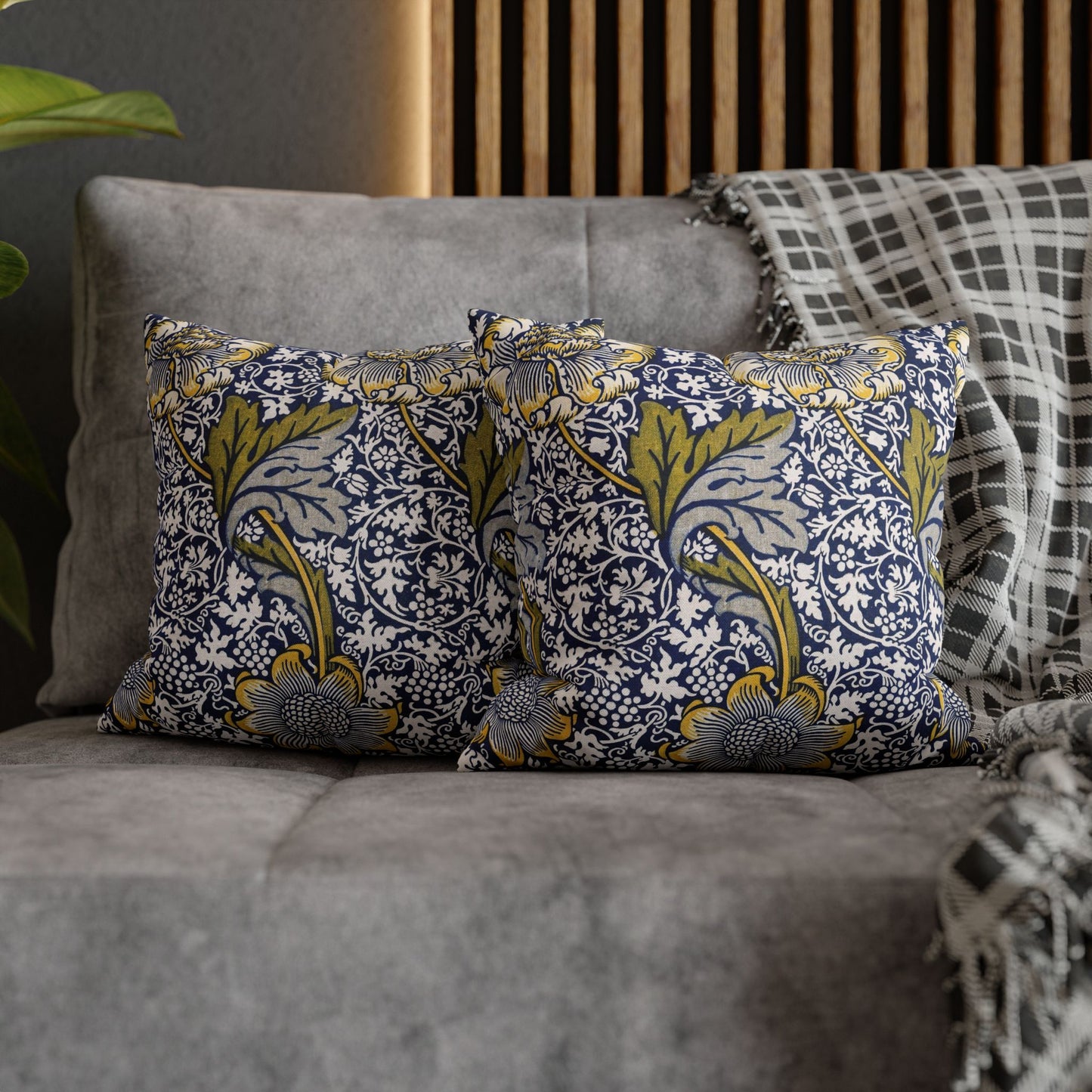 Decorative pillows with floral pattern on a gray sofa