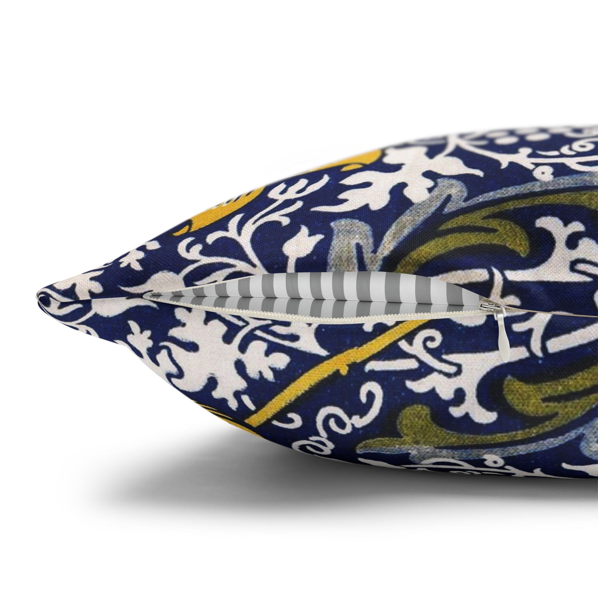 Decorative pillow with blue, white, and yellow floral pattern on a white background