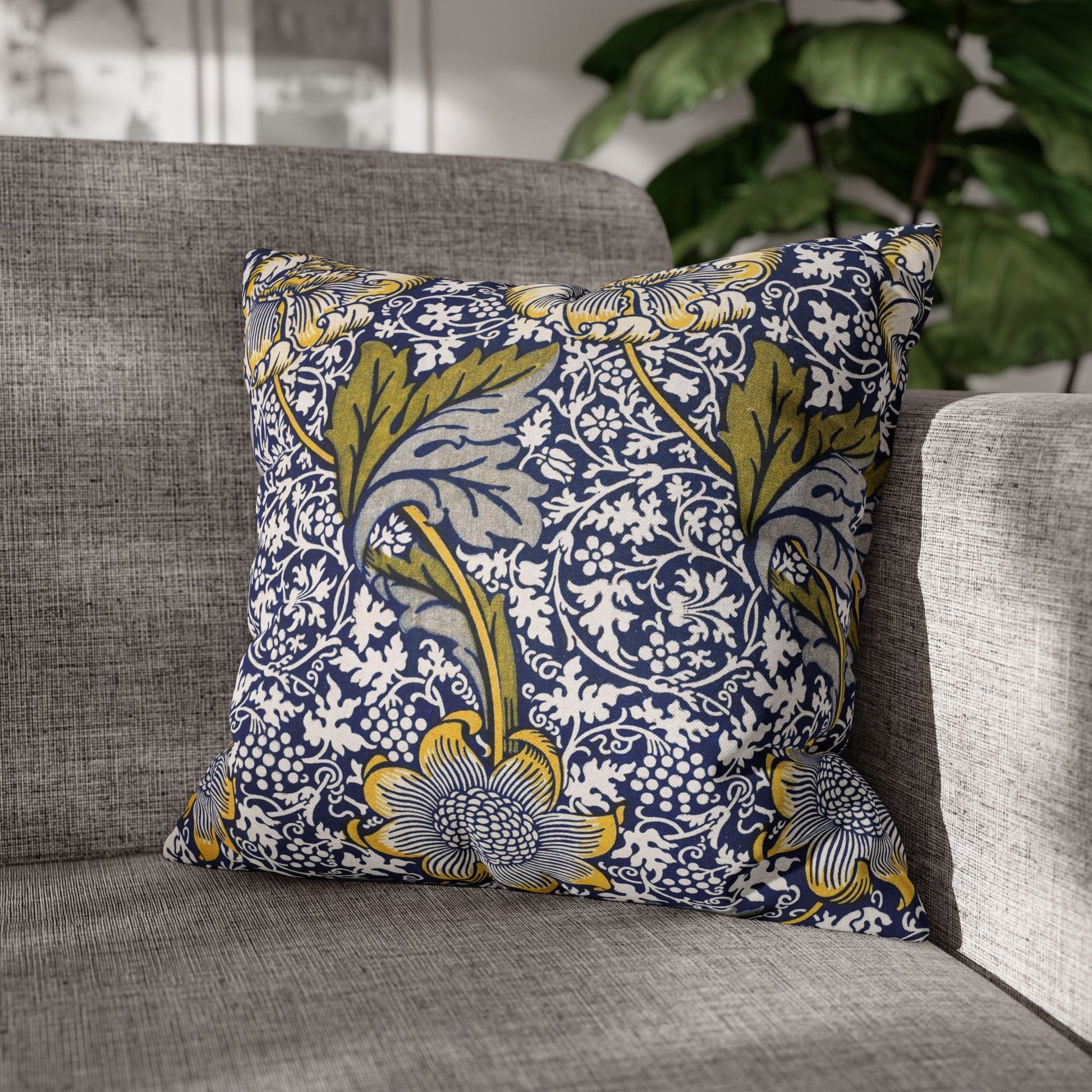 Decorative pillow with floral pattern on a gray sofa