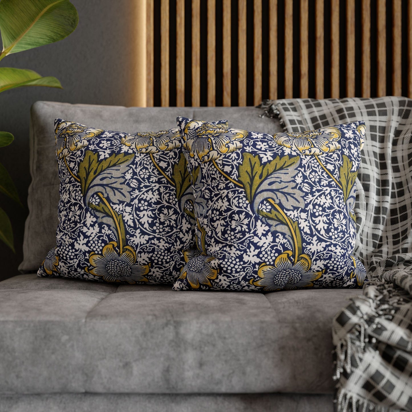Decorative pillows with floral pattern on a gray sofa