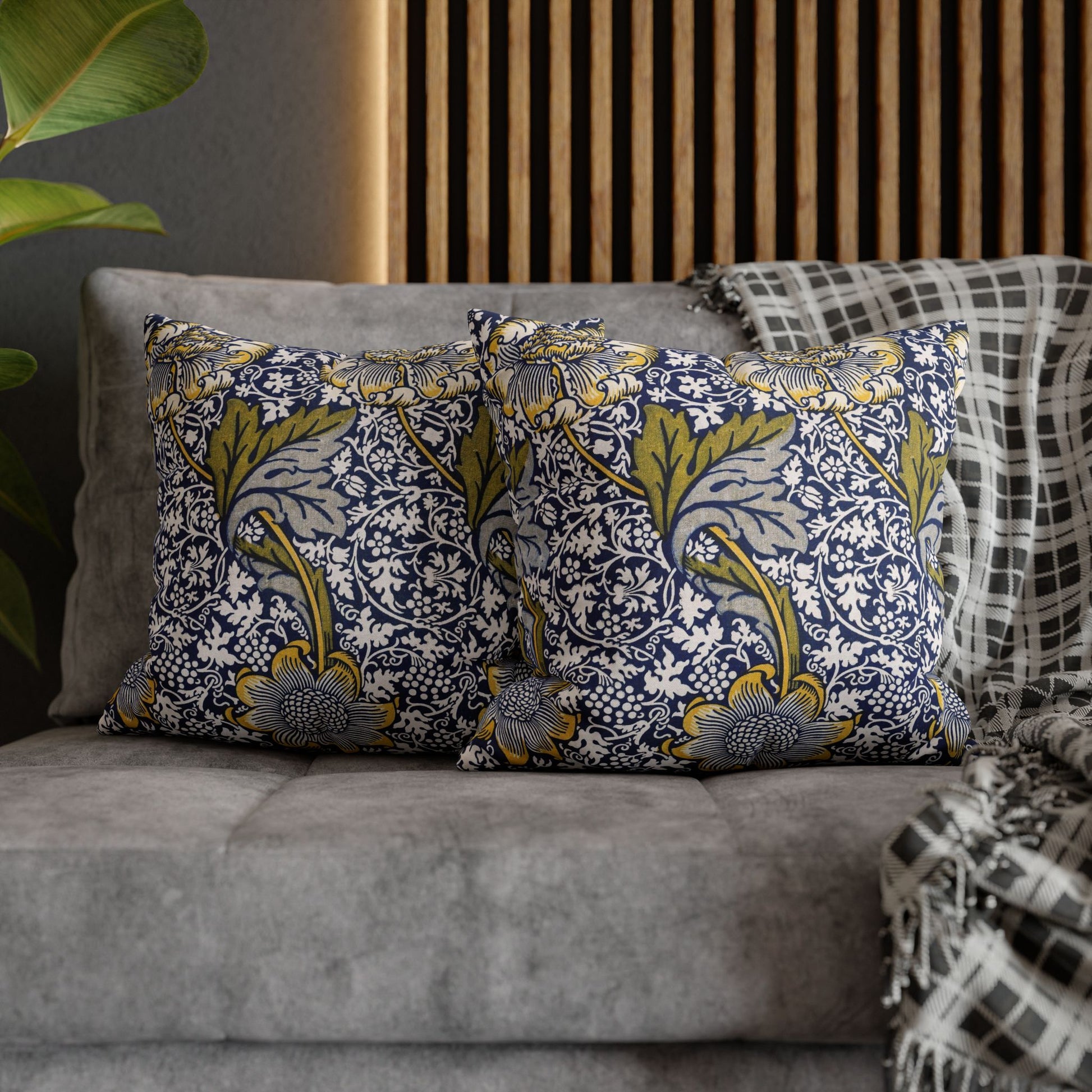 Decorative pillows with floral pattern on a gray sofa