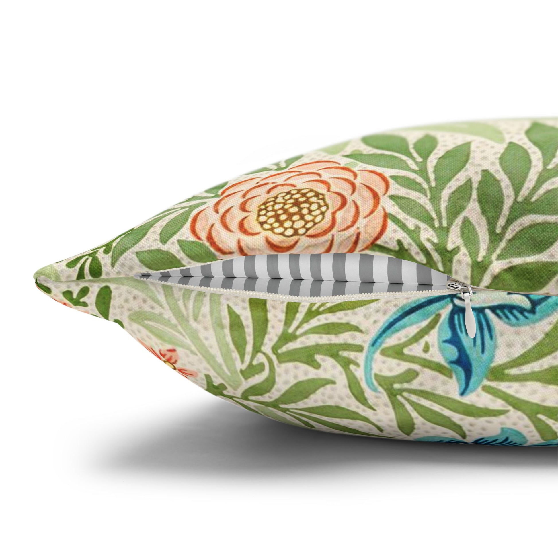 Decorative pillow with floral and bird pattern on a white background
