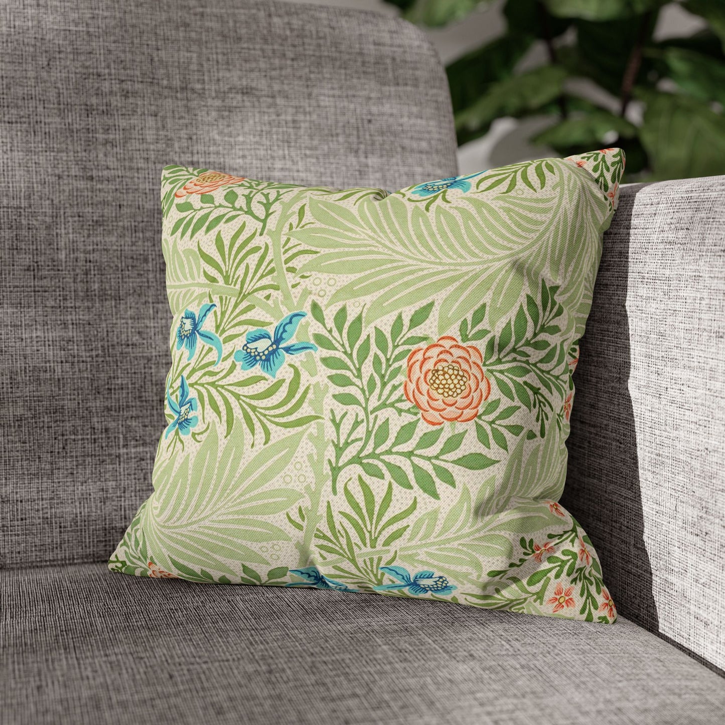 Decorative pillow with floral pattern on a gray sofa