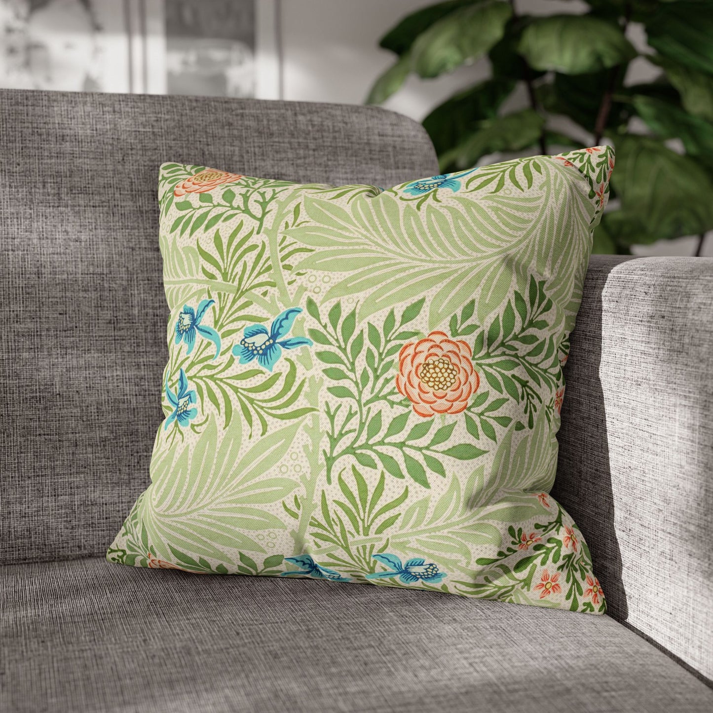 Decorative pillow with floral pattern on a gray sofa