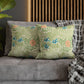 Floral patterned cushions on a gray sofa with a wooden headboard in the background.