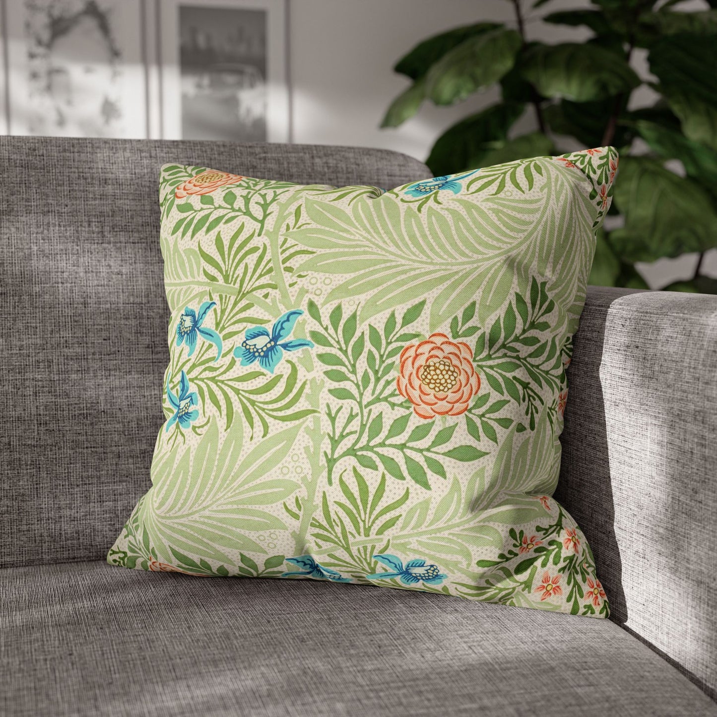Floral-patterned pillow on a gray sofa with a blurred indoor background