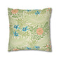 Decorative pillow with floral and leaf pattern on a white background