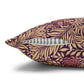 Decorative pillow with purple and gold leaf pattern on a white background