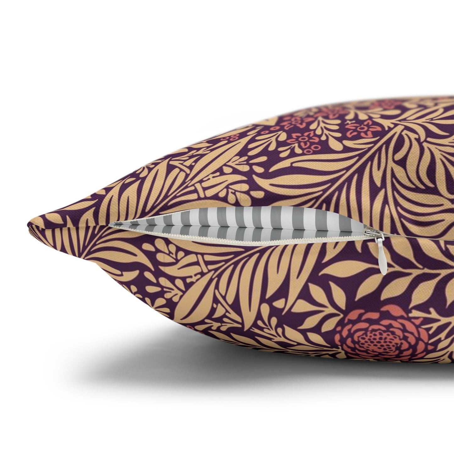 Decorative pillow with purple and gold leaf pattern on a white background