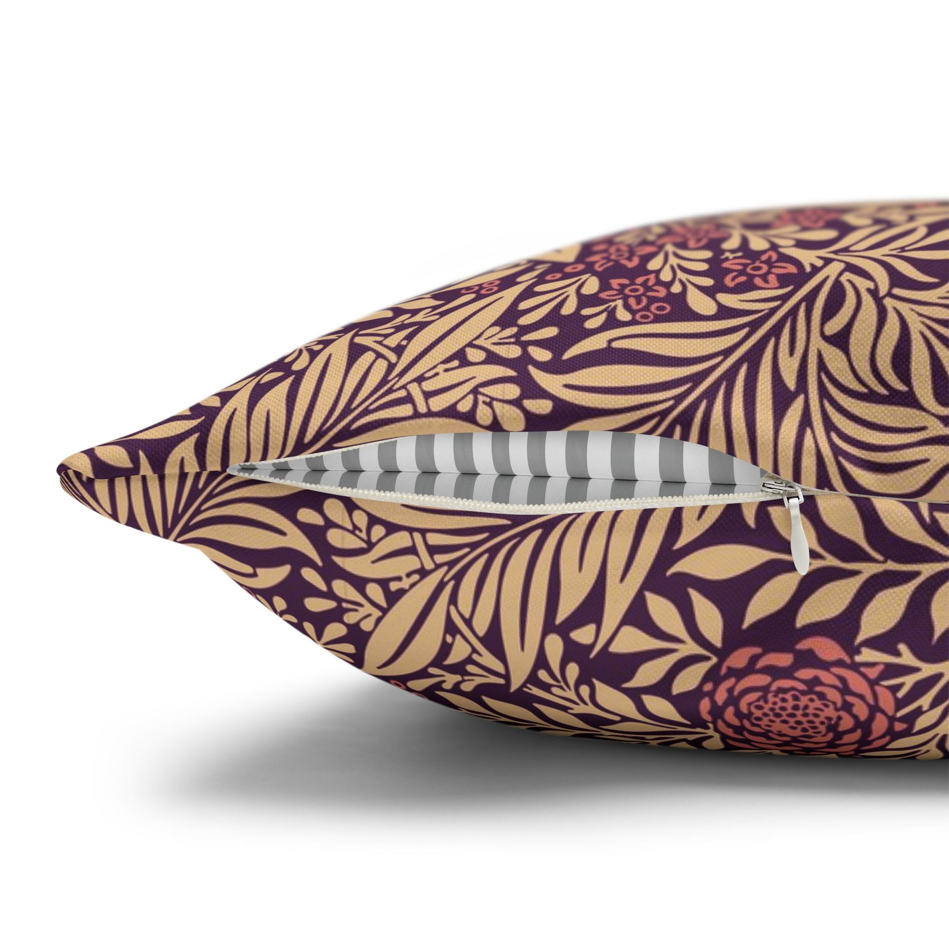 Decorative pillow with purple and gold leaf pattern on a white background